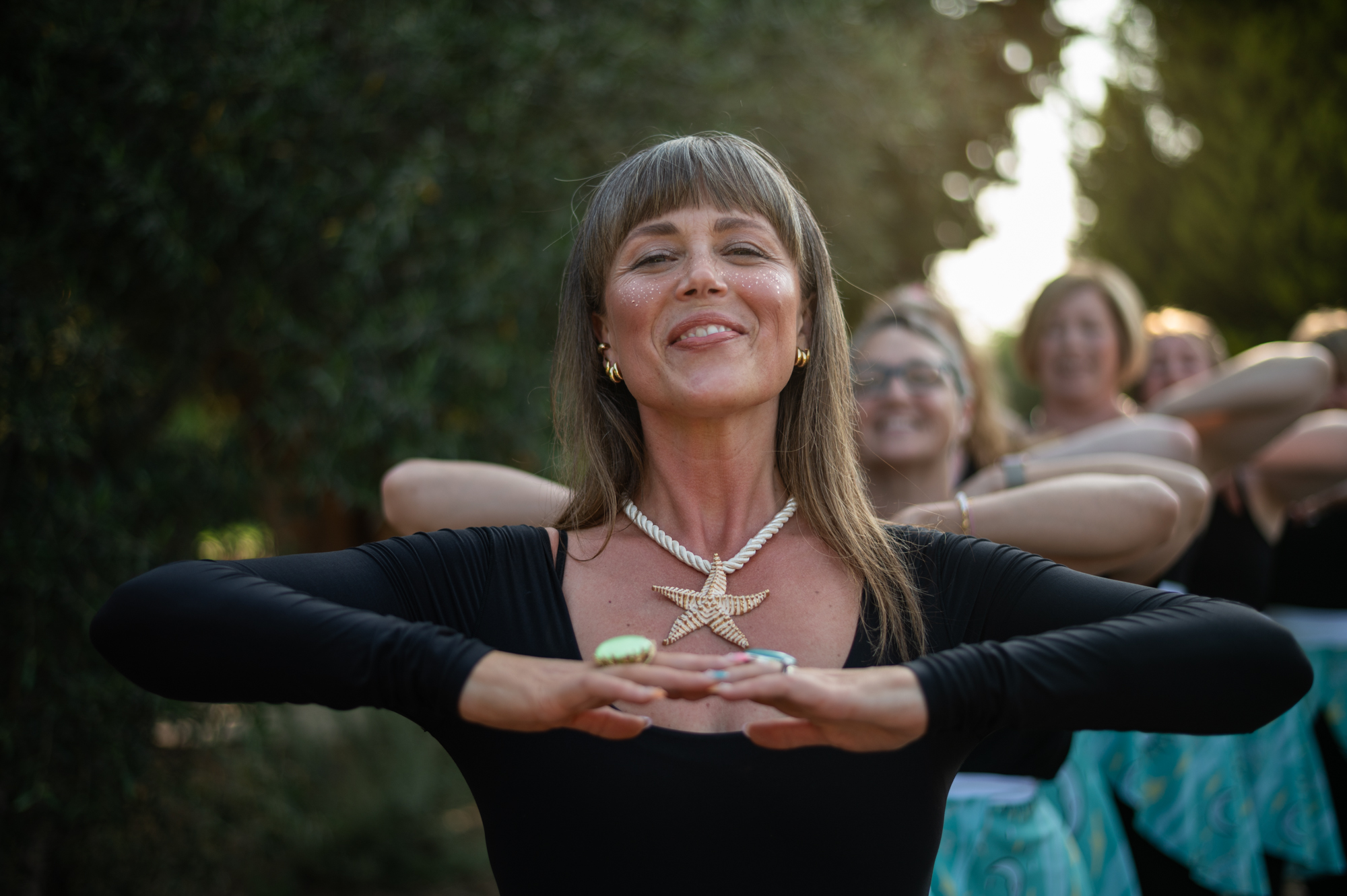 A joyful group moment photographed in an olive grove in Crete