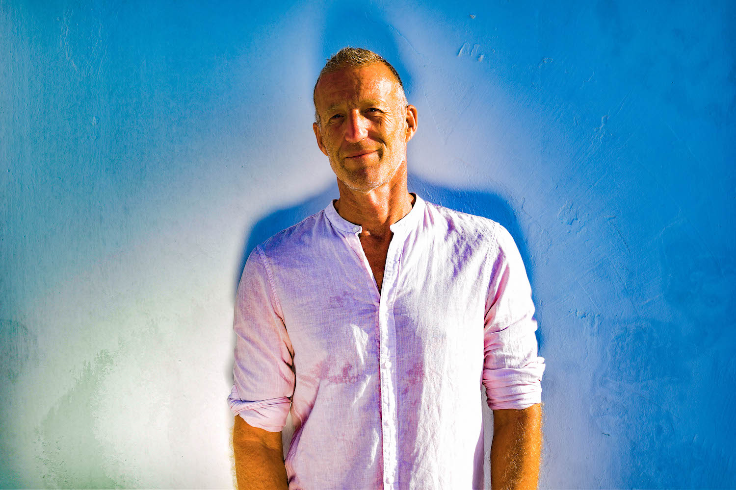 Portrait against a blue painted wall, Crete