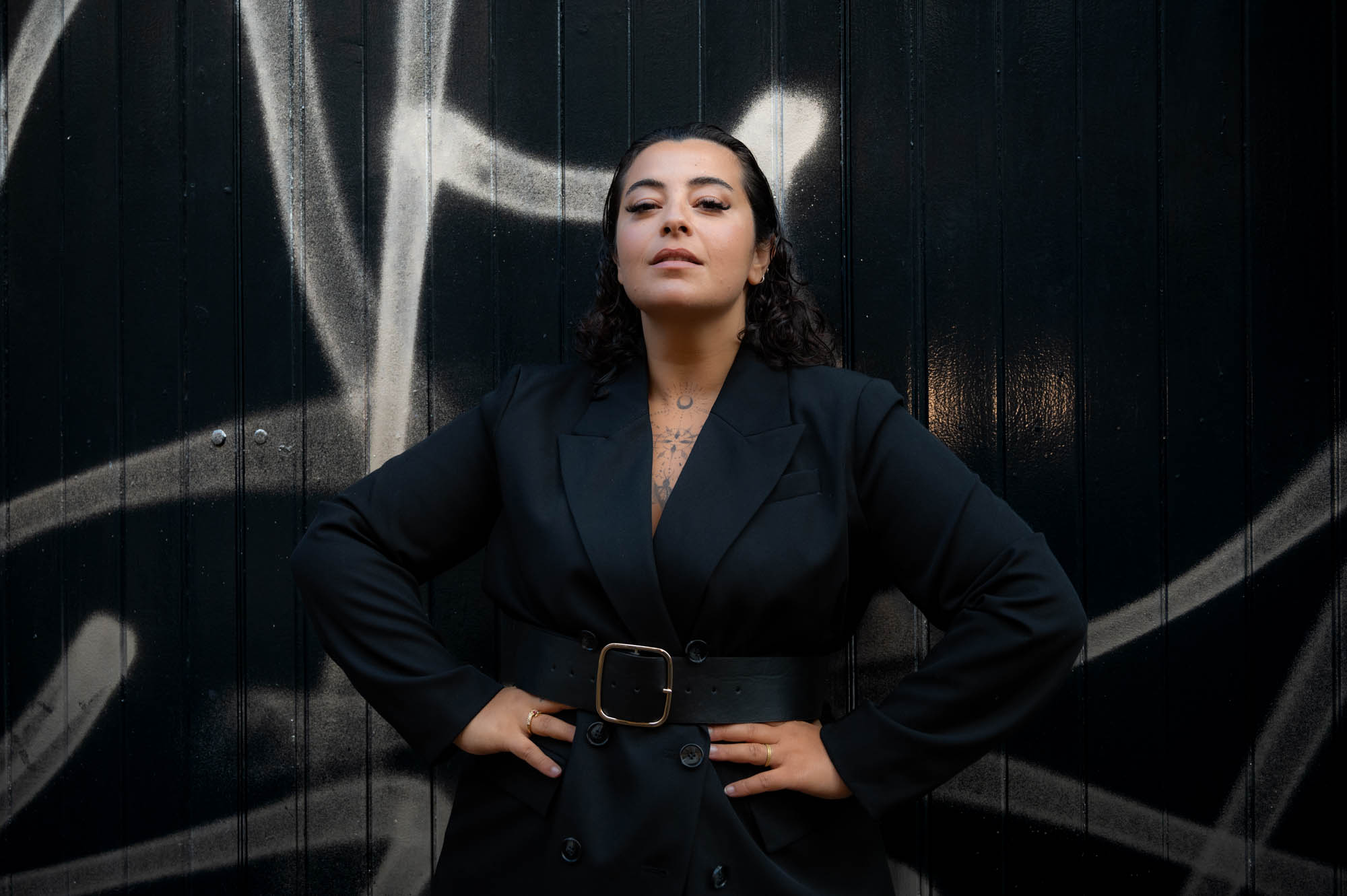 Portrait in black against a black painted door, London